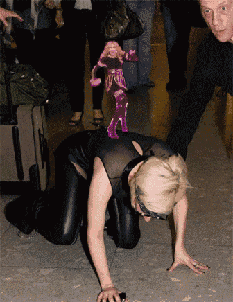 a woman is crawling on the floor with a pink doll on her back