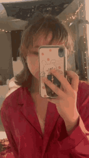 a girl is taking a picture of herself in a mirror