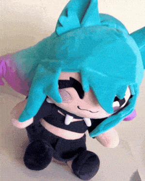 a stuffed animal with blue hair and a purple tail
