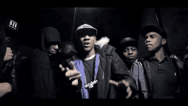 a group of men are posing for a photo and one of them is wearing a hoodie that says smokey jungle