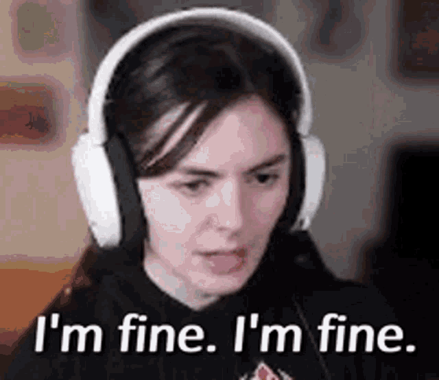 a woman is wearing headphones and saying `` i 'm fine , i 'm fine . ''