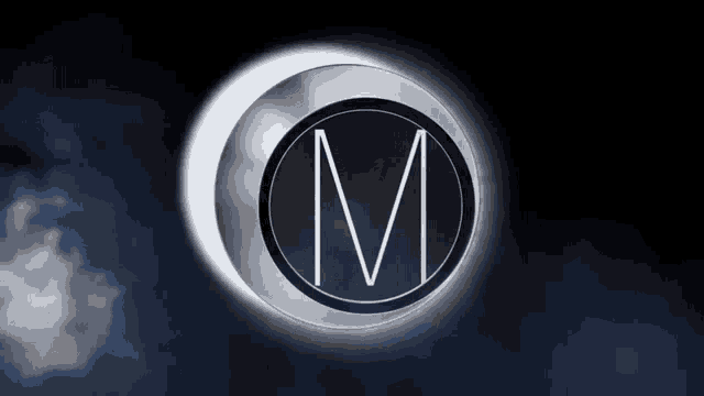 a circle with a letter m inside of it