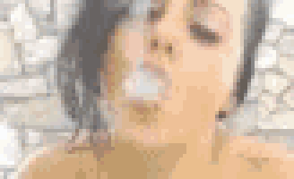 a woman is blowing a bubble with her mouth while smoking an electronic cigarette .