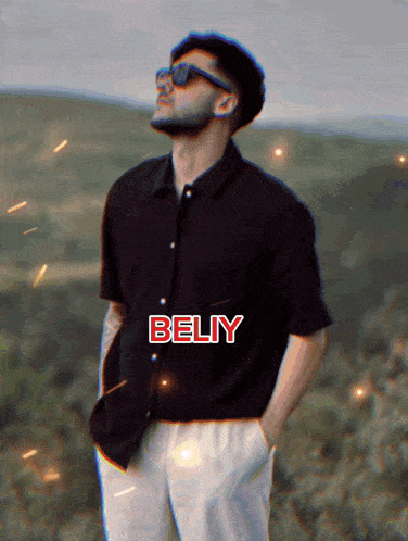 a man wearing sunglasses and a black shirt with the word beliy on the bottom