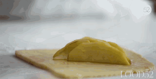 a slice of apple on a piece of puff pastry with food52 written on the bottom
