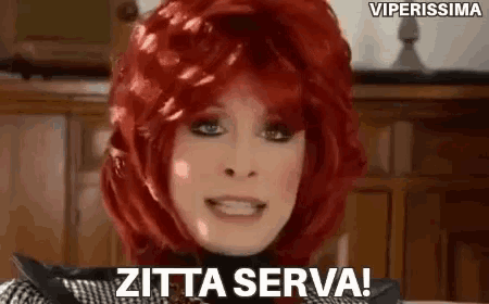 a woman with red hair is wearing a wig and saying zitta serva .