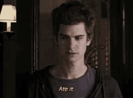 a man in a black shirt says ate it in a dark room