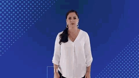 a woman stands in front of a blue background with speech bubbles that say oh !