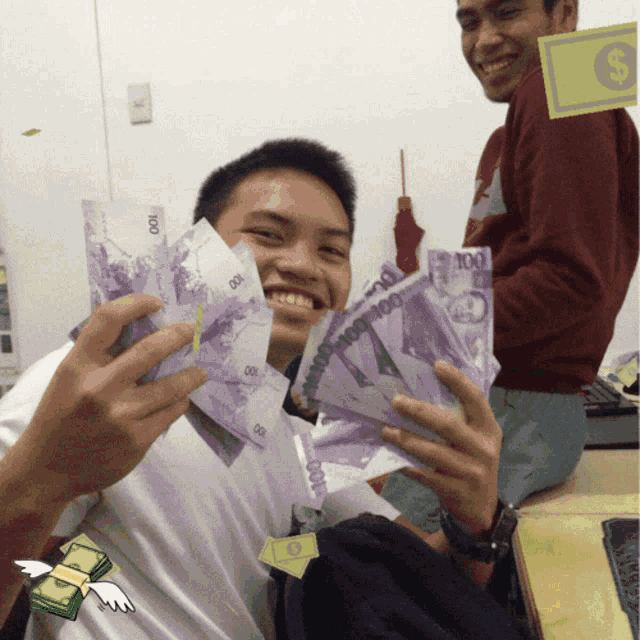 a man is holding a bunch of 100 bills