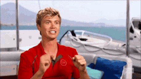 a man in a red shirt with tm on it