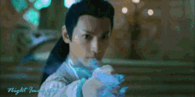 a man is holding a blue object in his hand .