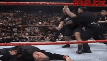 wrestlers in a ring with the word doom on the bottom