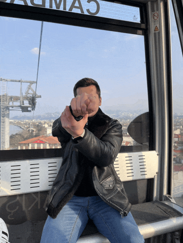 a man sitting in a ferris wheel with a sign that says cimao