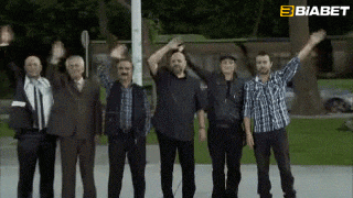 a group of men standing next to each other with their arms in the air and a biabet logo in the corner