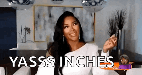 a woman in a white dress is sitting in a living room with the words yasss inches .