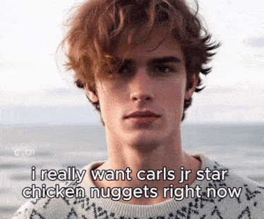 a young man with red hair says i really want carls jr star chicken nuggets right now in a sweater