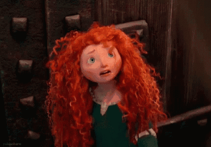 a cartoon character with red hair is holding her head in pain .
