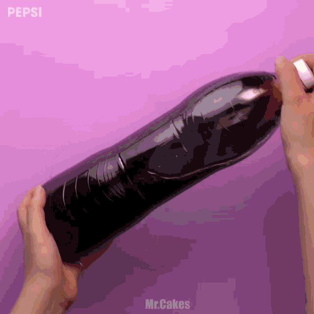 a person is opening a bottle of pepsi on a pink background