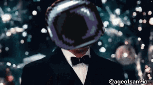 a man in a suit and bow tie has a purple object on his head