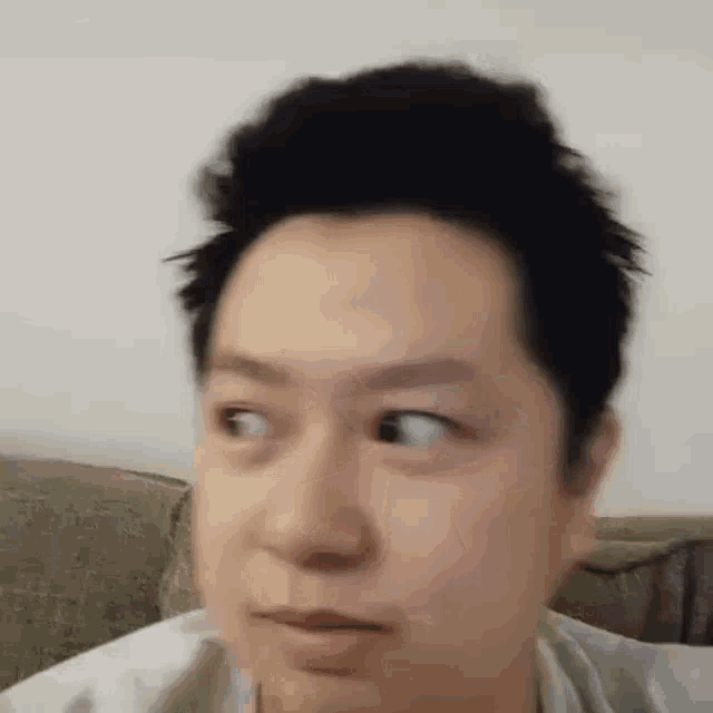 a close up of a man 's face making a funny face .