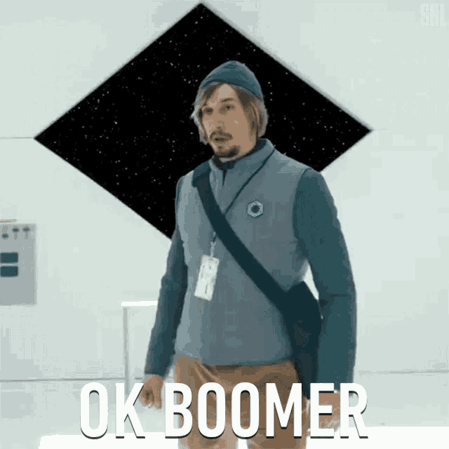 a man with a lanyard around his neck says ok boomer in white letters