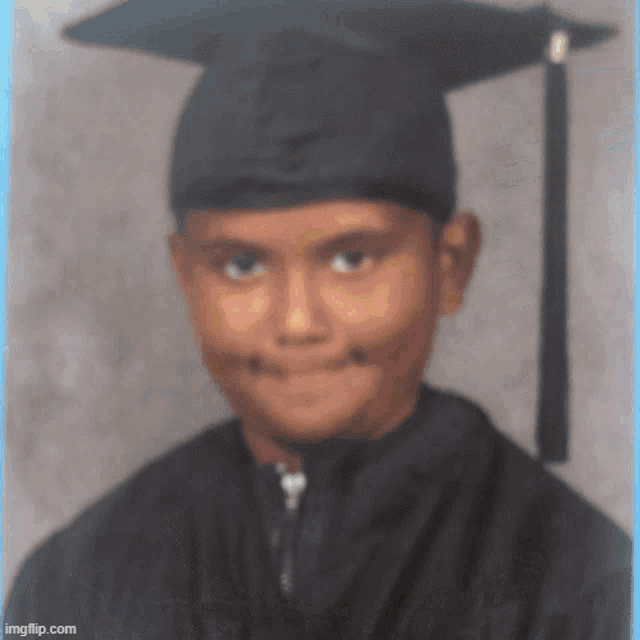 a young boy wearing a graduation cap and gown is smiling for the camera