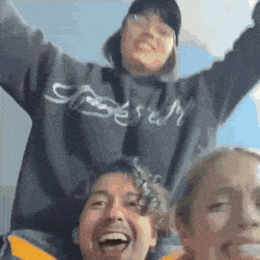a man wearing a sweatshirt that says ' jesus ' on it