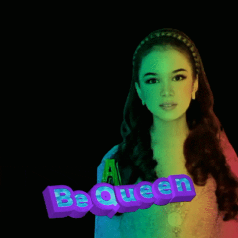 a woman with a purple sign that says be queen