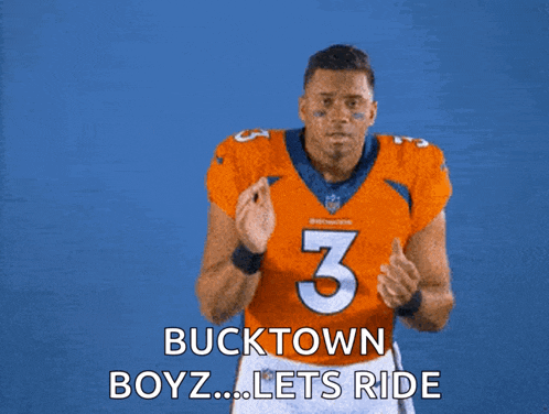 a man in an orange jersey with the number 3 on it says " bucktown boyz lets ride "