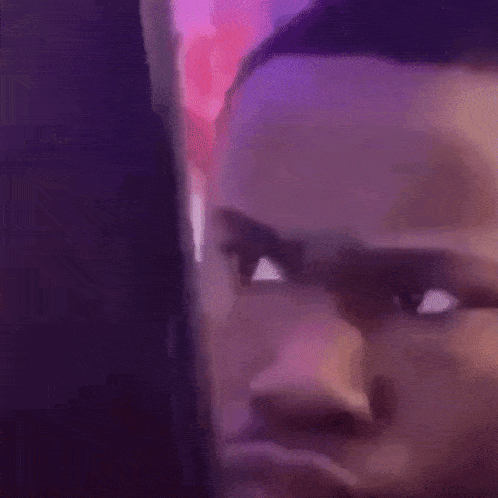 a close up of a man 's face looking at a cell phone screen .