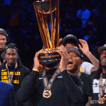 a man holds up a trophy that says netflix on it