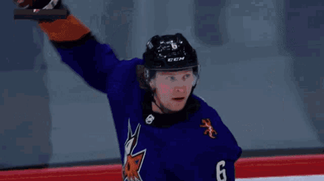 a hockey player in a purple jersey with a fox on the front