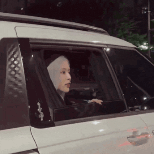 a woman in a white car with a sticker on the side that says ' a '