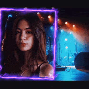 a girl is standing in front of a stage with a purple light surrounding her