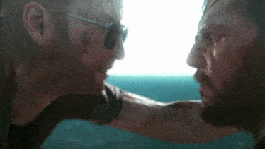 two men are looking at each other in a video game .