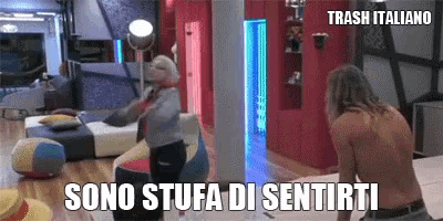 a man without a shirt is standing next to a woman in a room with the words sono stufa di sentirti on the bottom