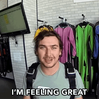 a man in a green shirt says i 'm feeling great in front of clothes