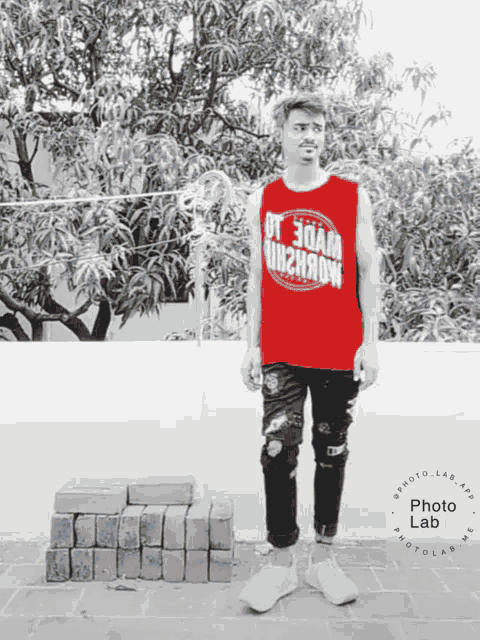 a man wearing a red tank top that says photo lab on it