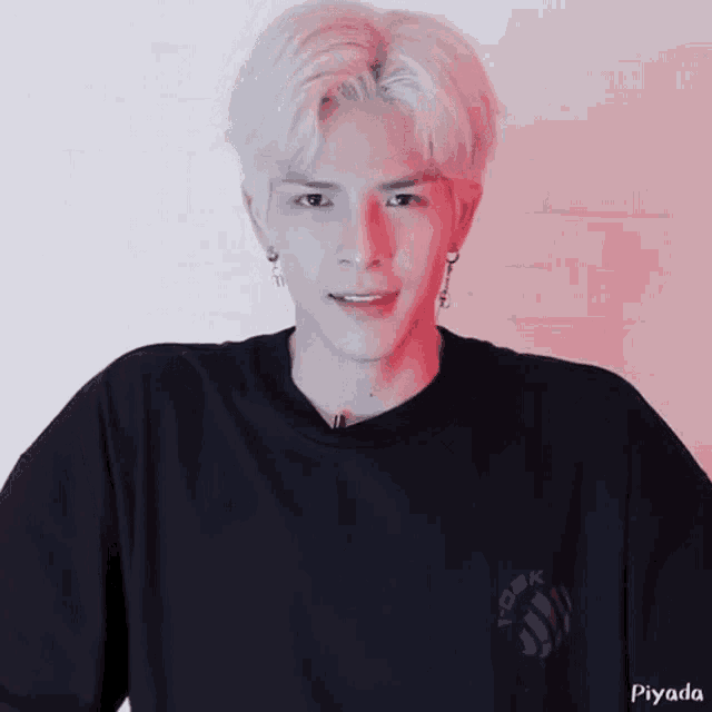 a man with white hair is wearing a black t-shirt that says piyada on it