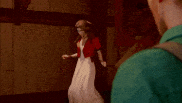 a man in a green shirt is standing next to a woman in a white dress