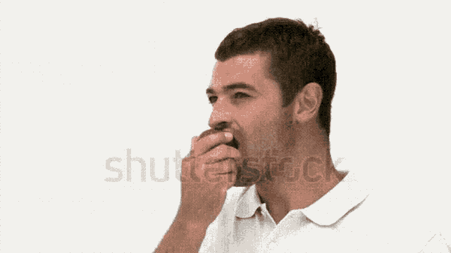 a man in a white shirt is eating an apple against a white background .