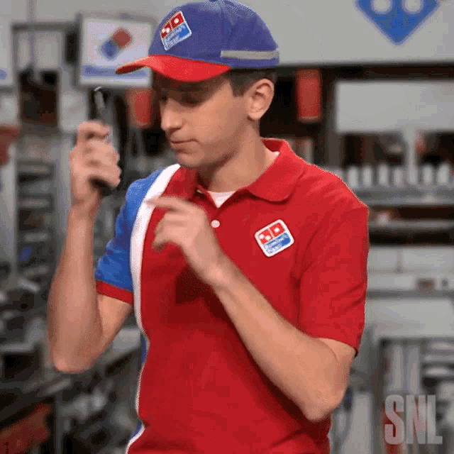 a man wearing a domino 's hat and polo shirt