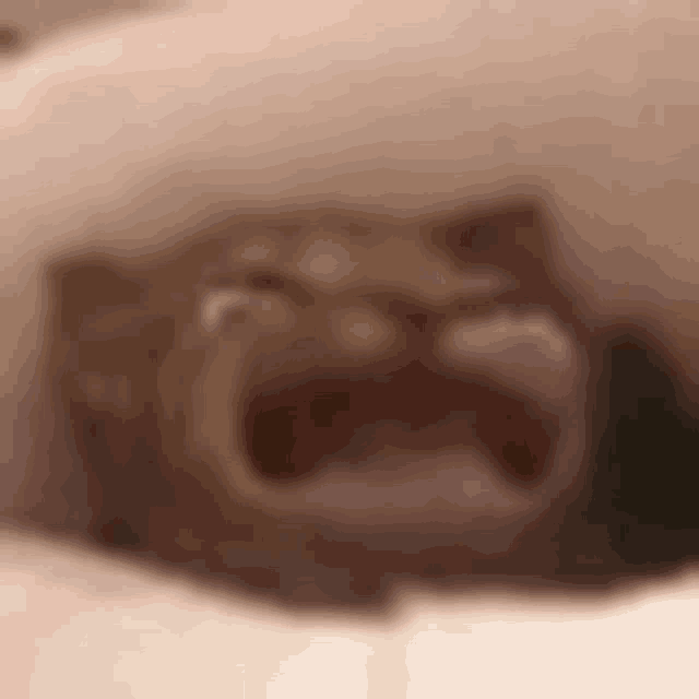 a close up of a person 's face with their mouth open and tears running down their face .