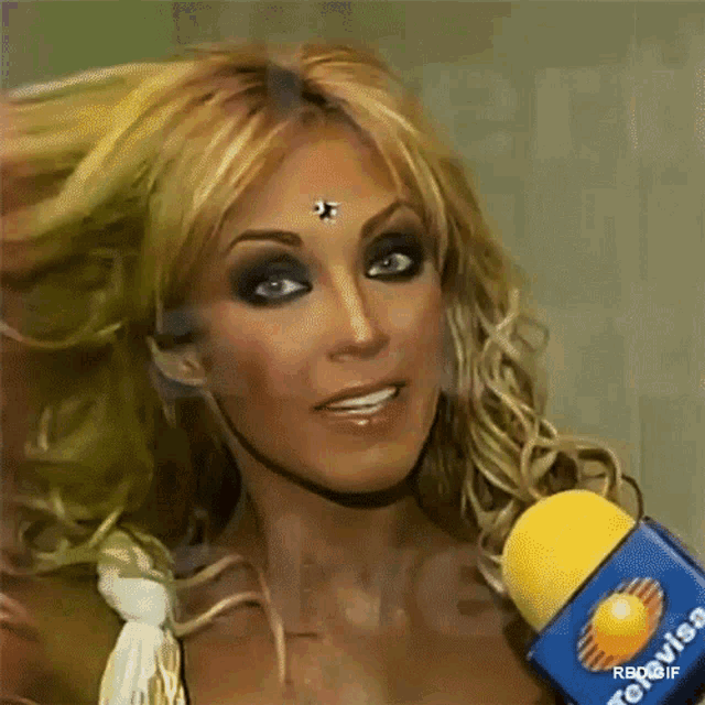 a close up of a woman with a yellow microphone that says tevisa on it