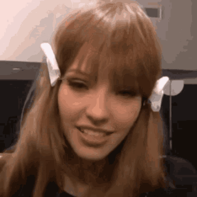 a close up of a woman 's face with a wig on her head .