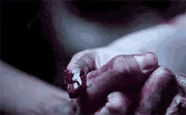 a close up of a person 's hand with blood on it .