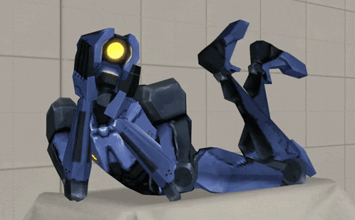 a blue robot with a yellow eye is laying on the floor