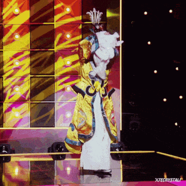 a person in a costume on a stage with xtecrystal written below them