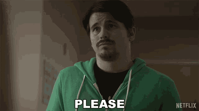 a man in a green sweatshirt says please