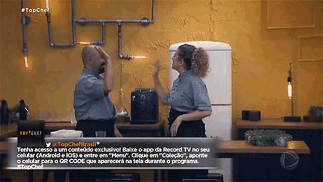 a man and a woman are standing in front of a white refrigerator in a kitchen with a sign that says #topchef